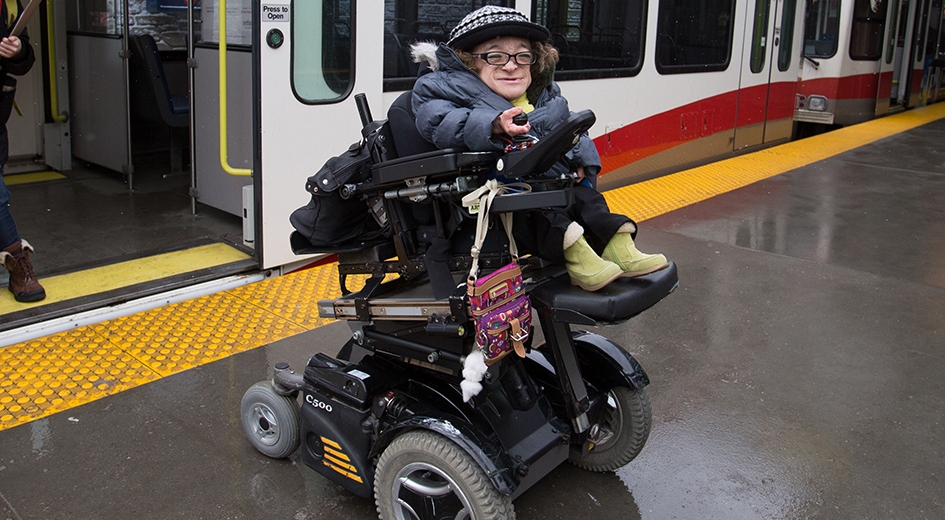 person in a wheelchair mobility device exiting the CTrain
